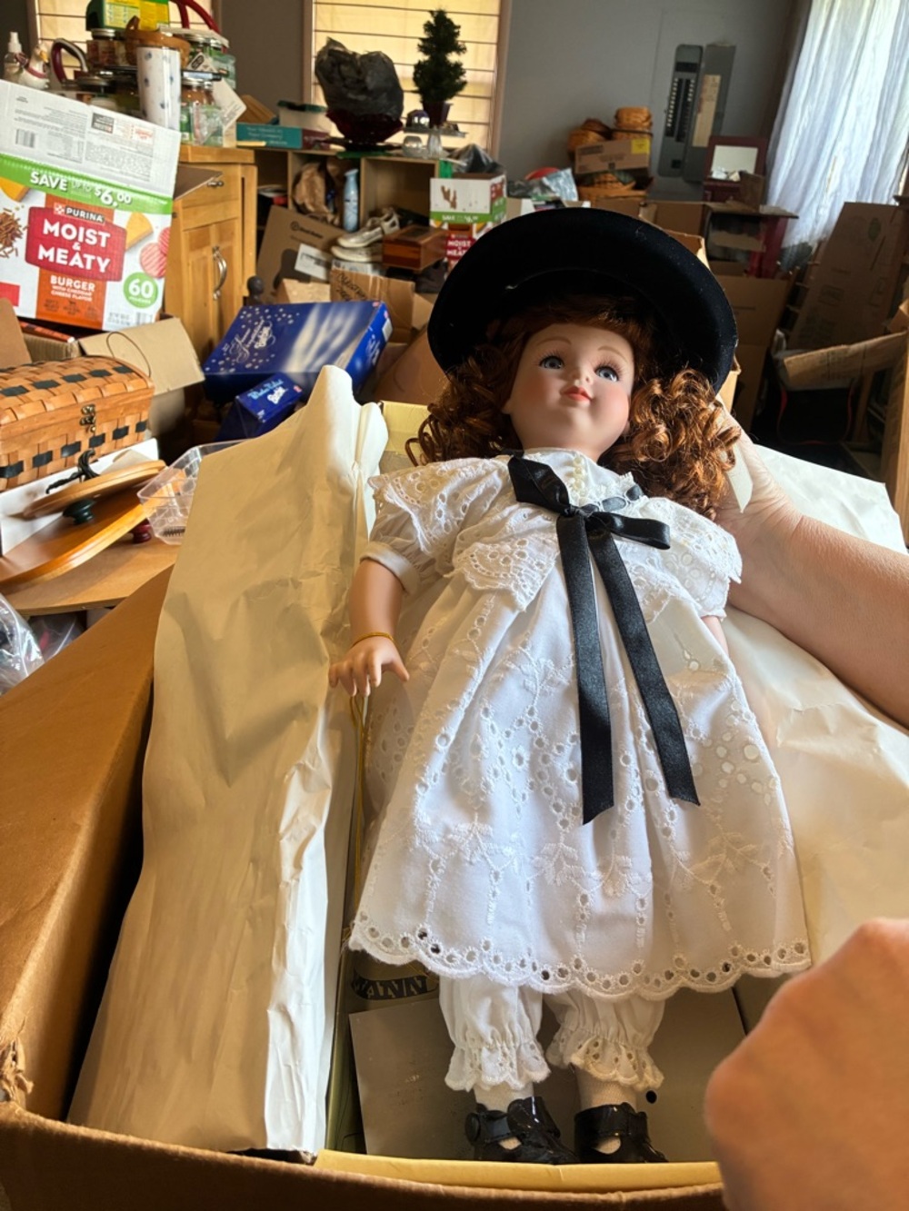 Classic Porcelain Doll in White Dress with Black Hat and Ribbon